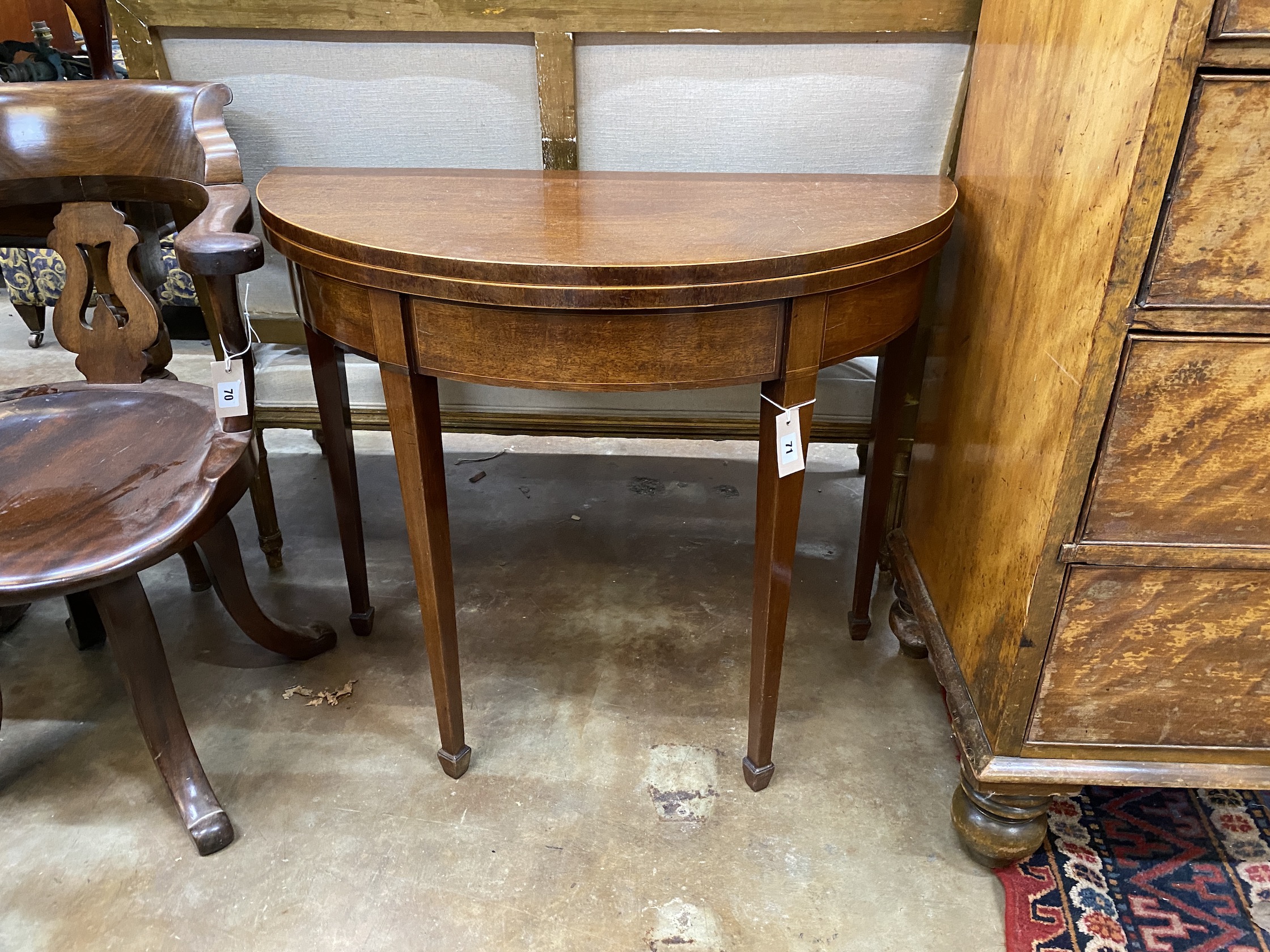 A George III mahogany demi-lune folding tea table, width 89cm, depth 44cm, height 74cm